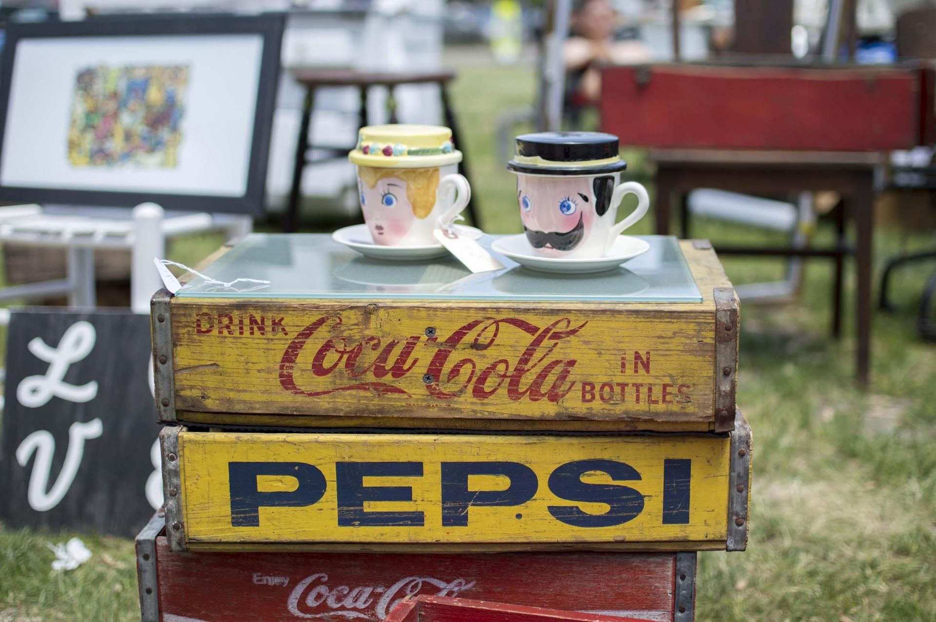 Antique coffee cups and soda crates.