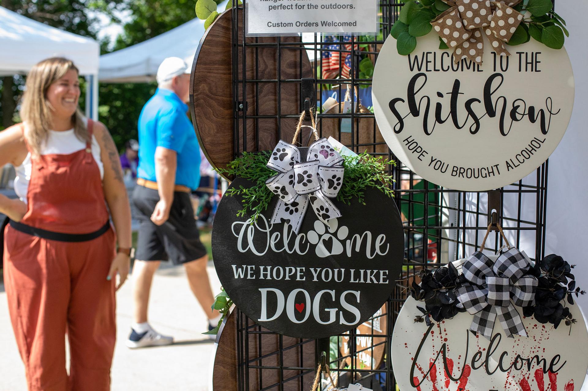 A bystander looking at trinkets at the Artisan Fair