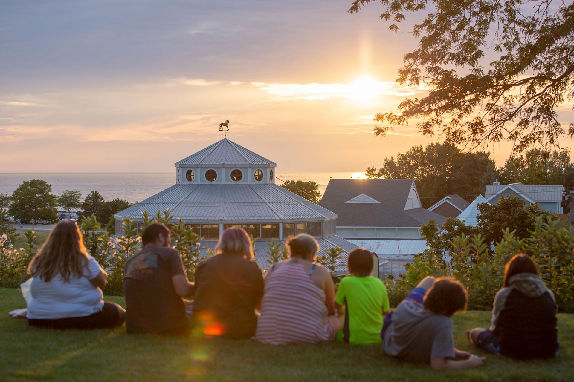 A family watching the sunset on while on Lake Bluff Park