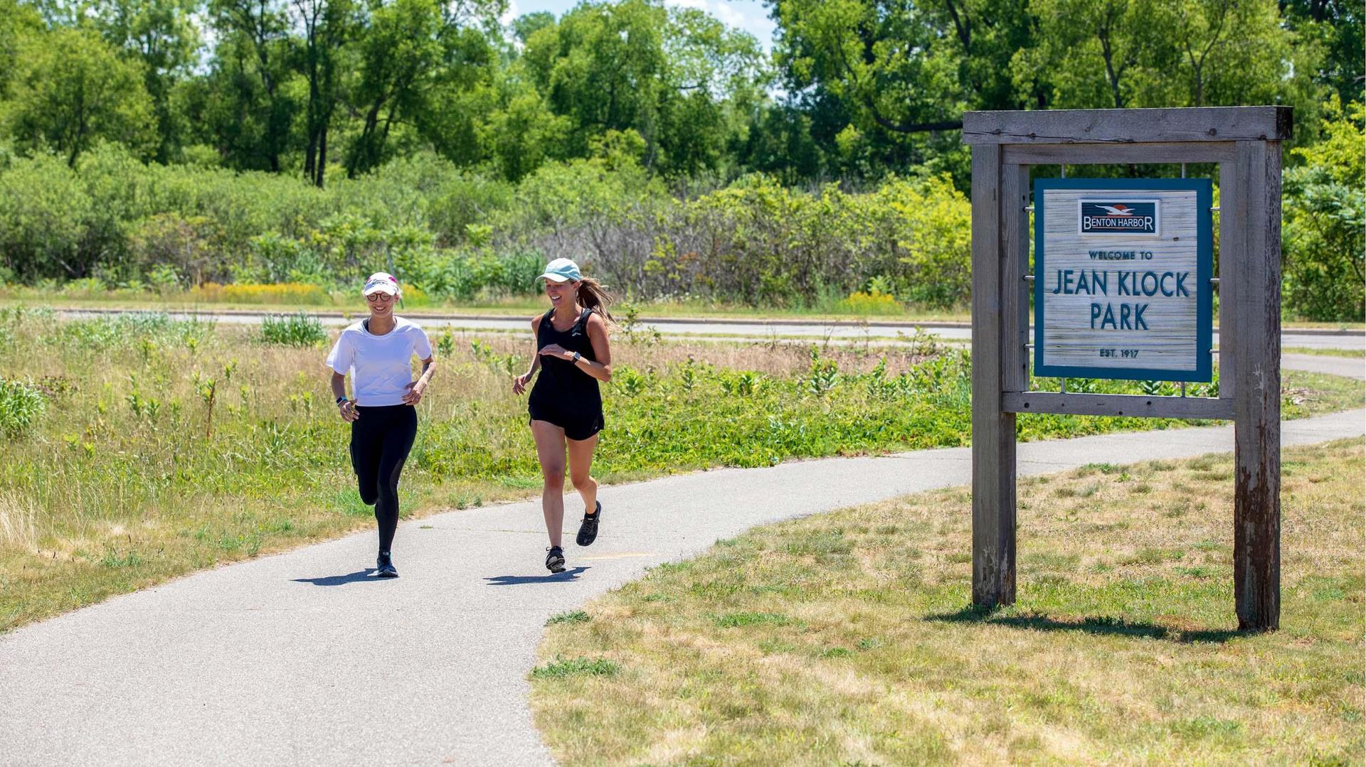 Two people running on the trail at Jean Klock.