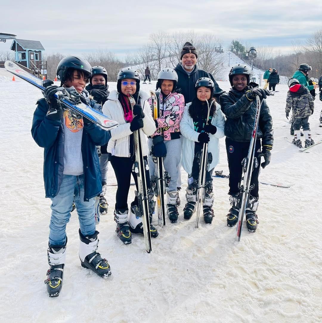 A group of people getting ready to ski.