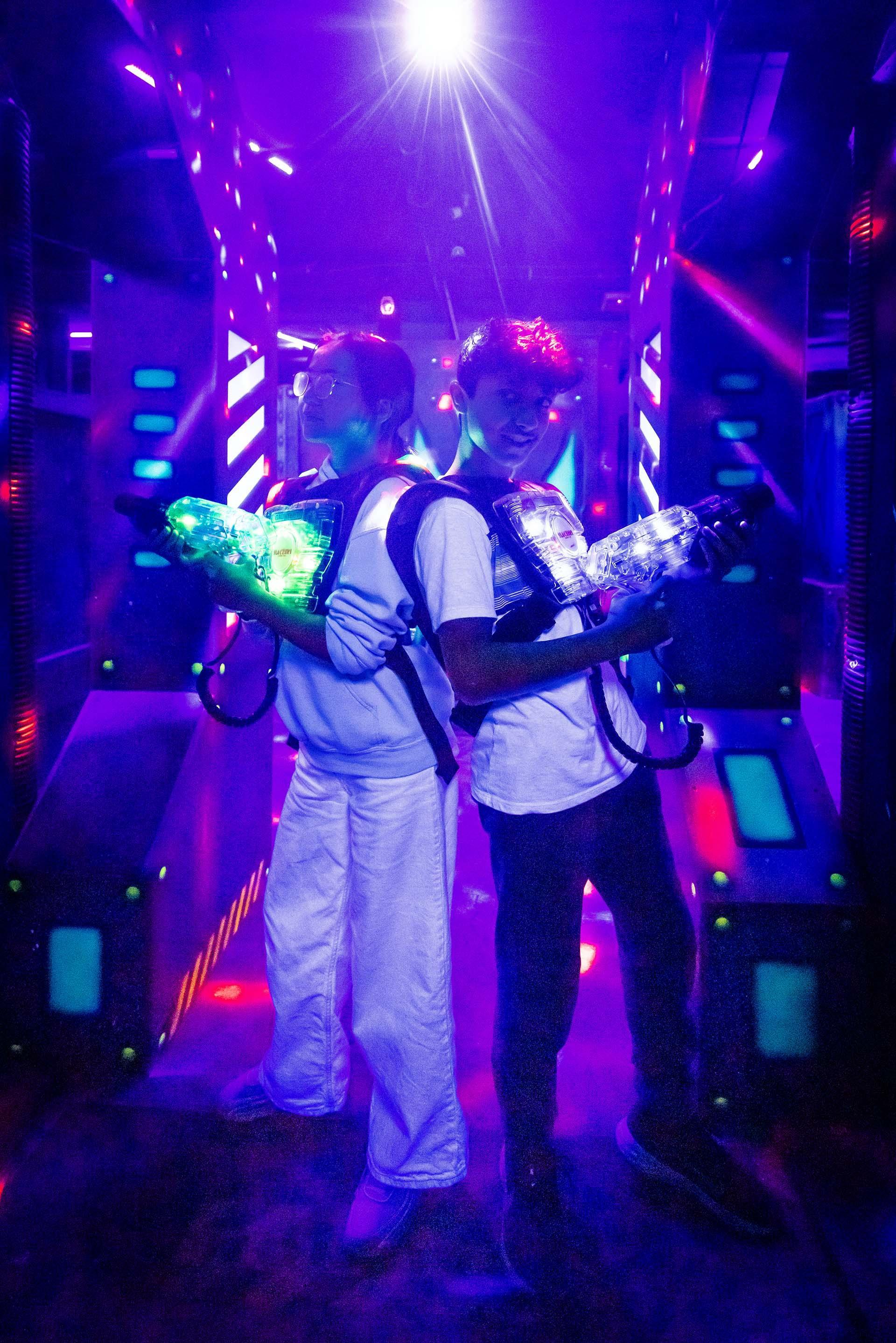 Two kids playing laser tag at Slackers