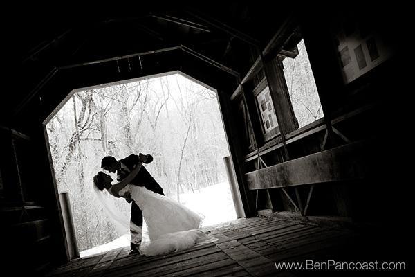 Bride and groom on a bridge in the winter.