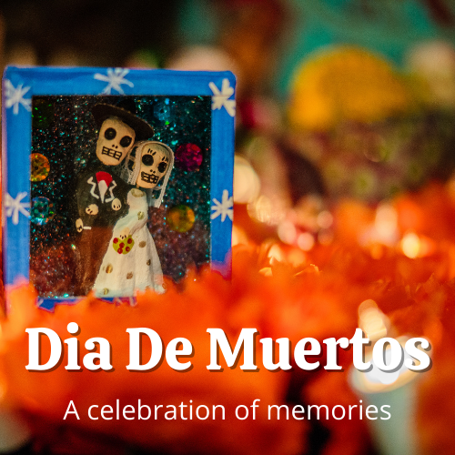 Small calavera couple inside a small handmade altar behind candles and orange marigolds with the words "Dia de Muertos: A Celebration of Memories" overlaid