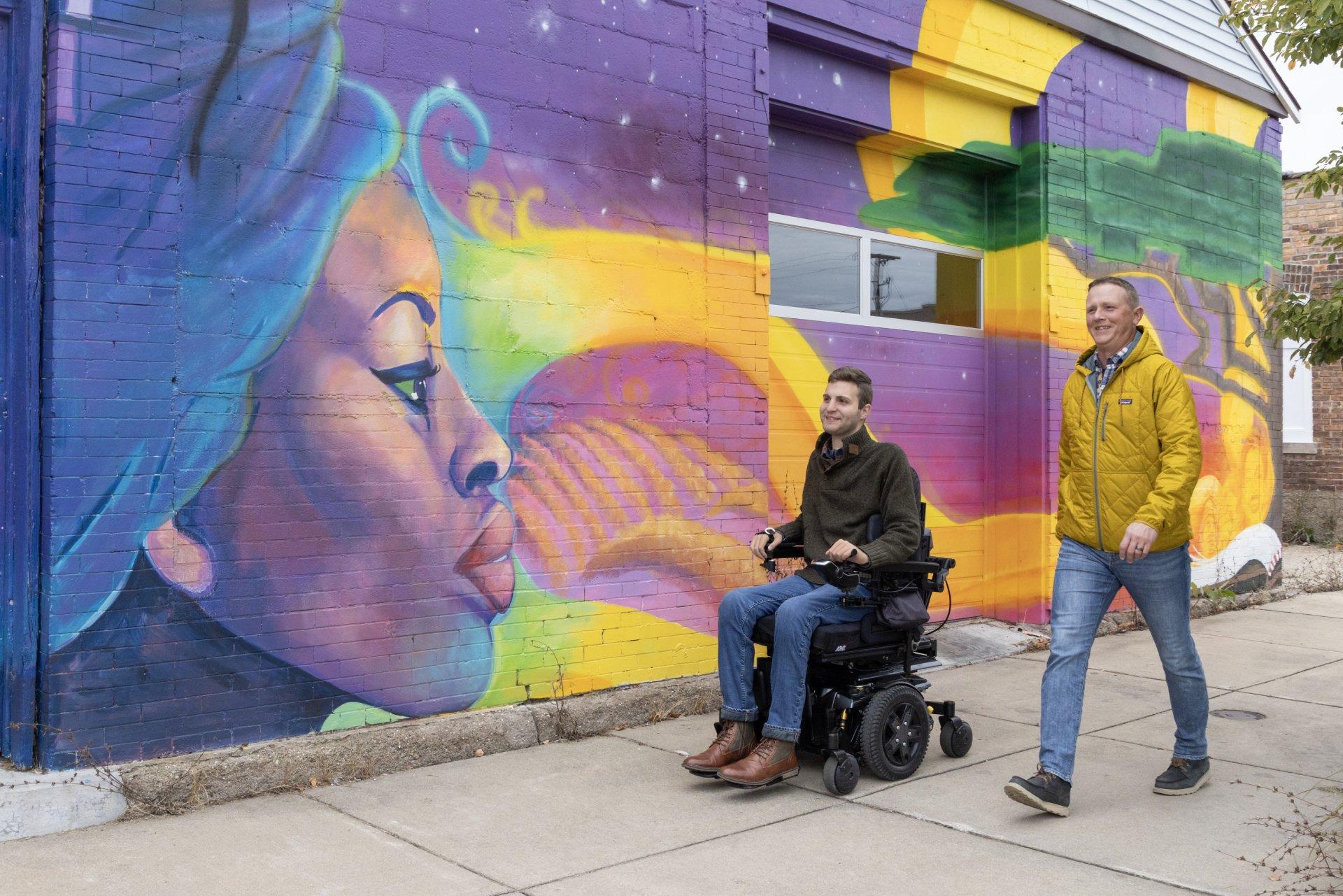 accessible mural two men on the sidewalk in benton harbor one is in a wheelchair