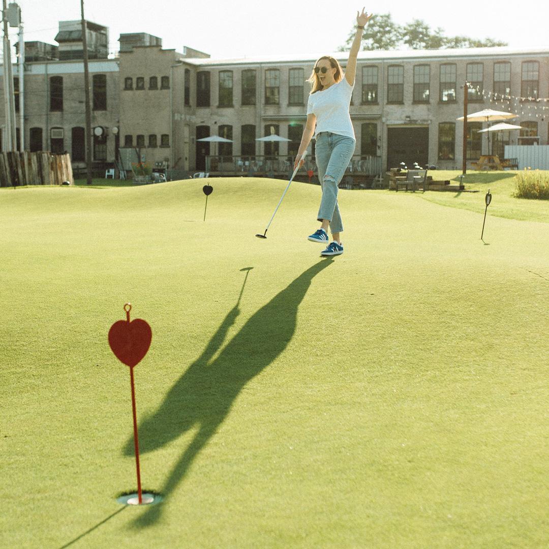 A woman playing on the putting green at Welter