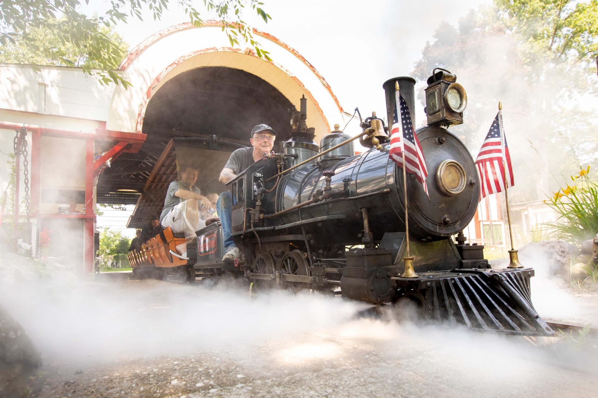 a man driving a train at eden springs park