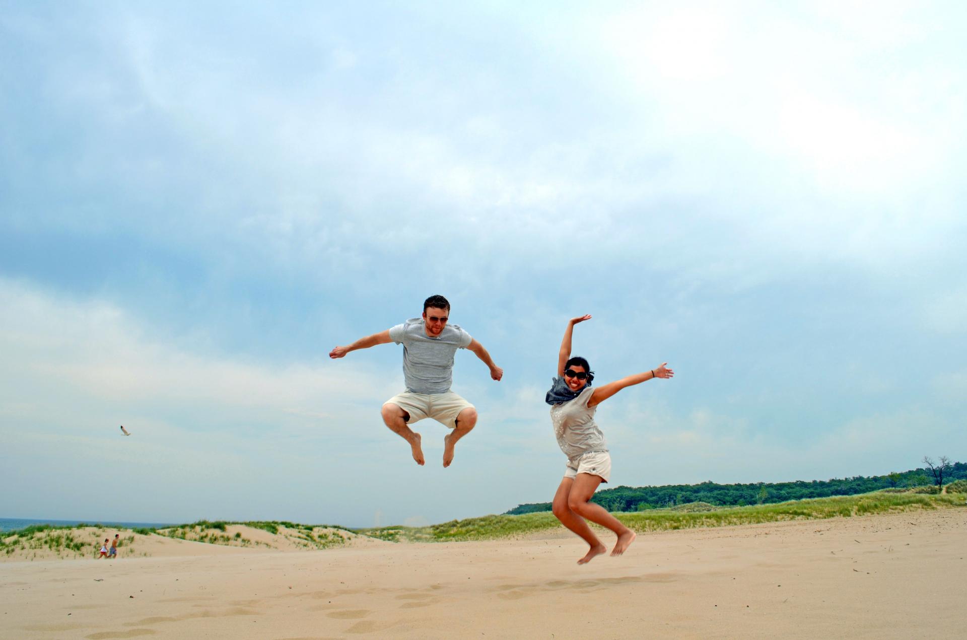 A-couple-jumping-in-the-sand