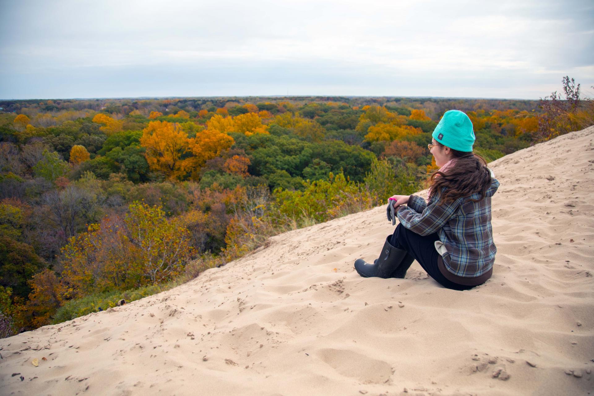 Girl-sitting-on-top-of-a-dune-enjoying-the-view