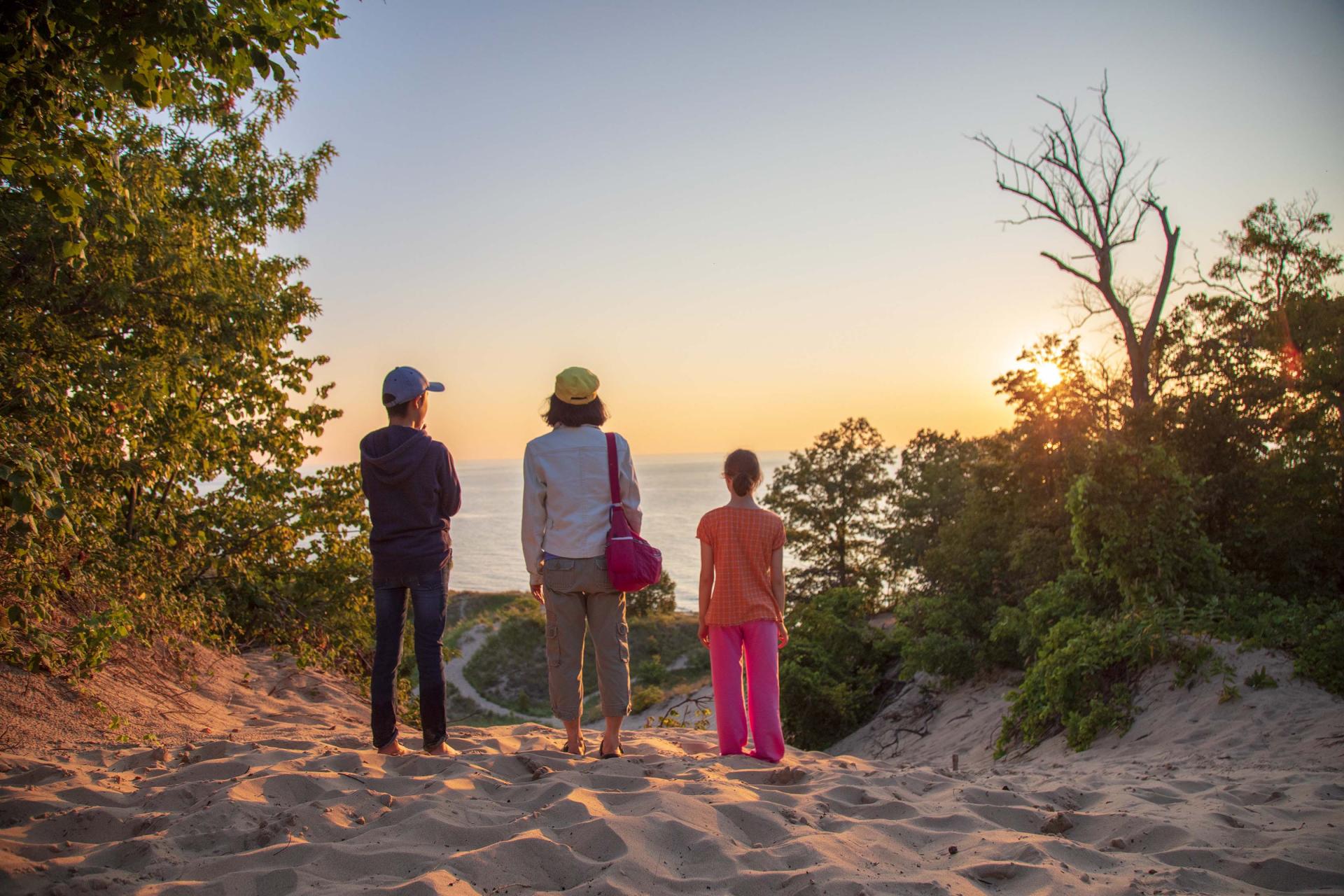 A-woman-and-two-children-watching-a-sunset