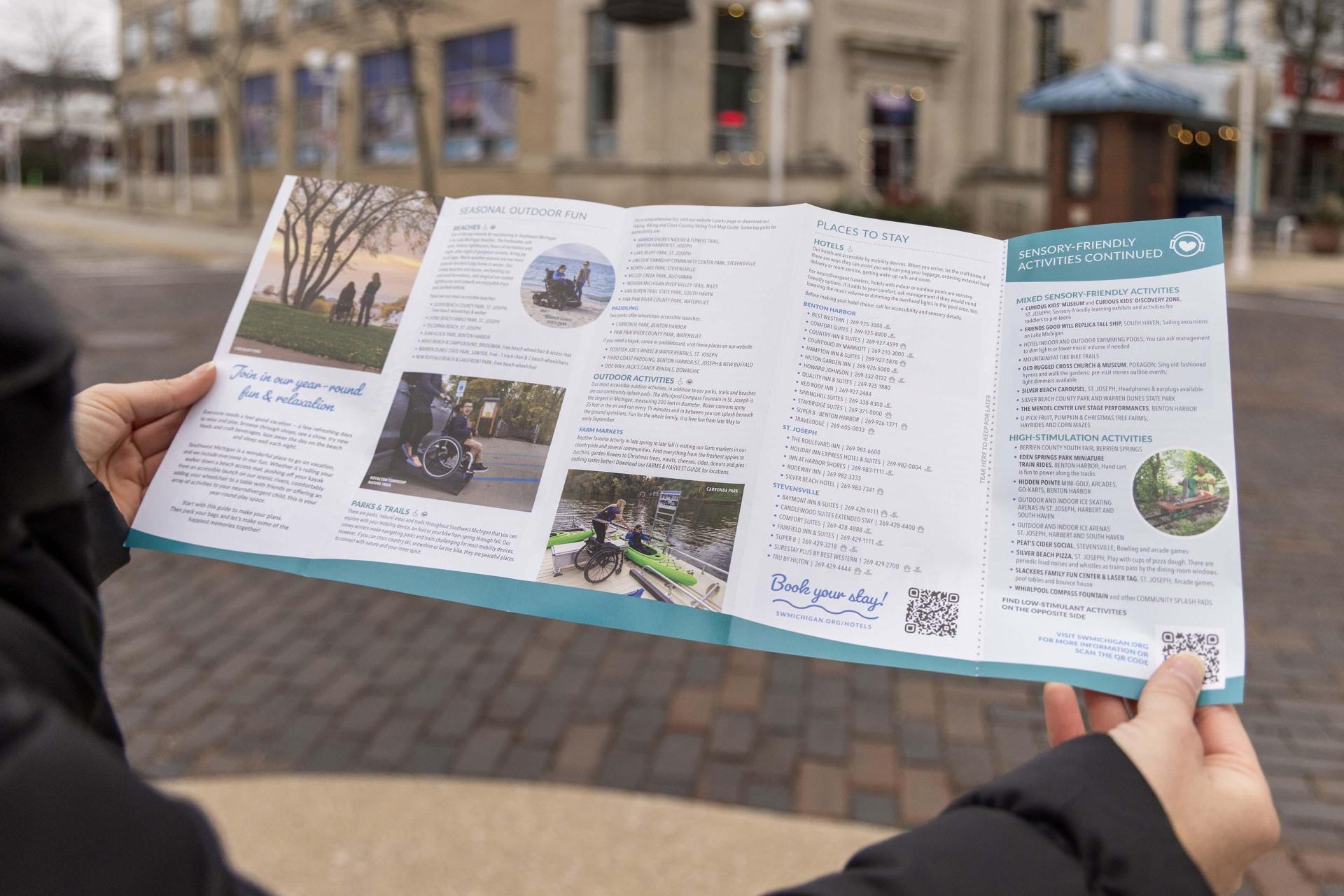 a person holding a brochure about accessibility 