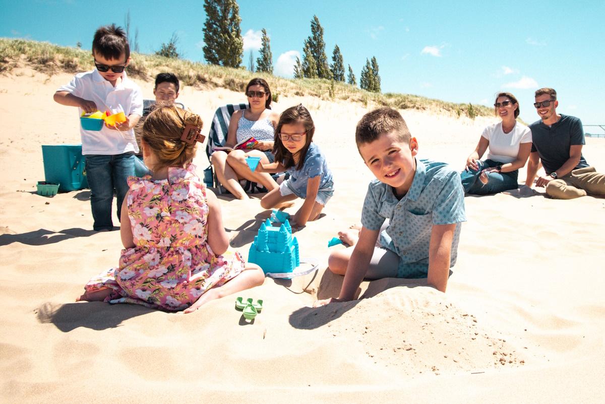 two families enjoying Tiscornia Beach on a sunny summer day