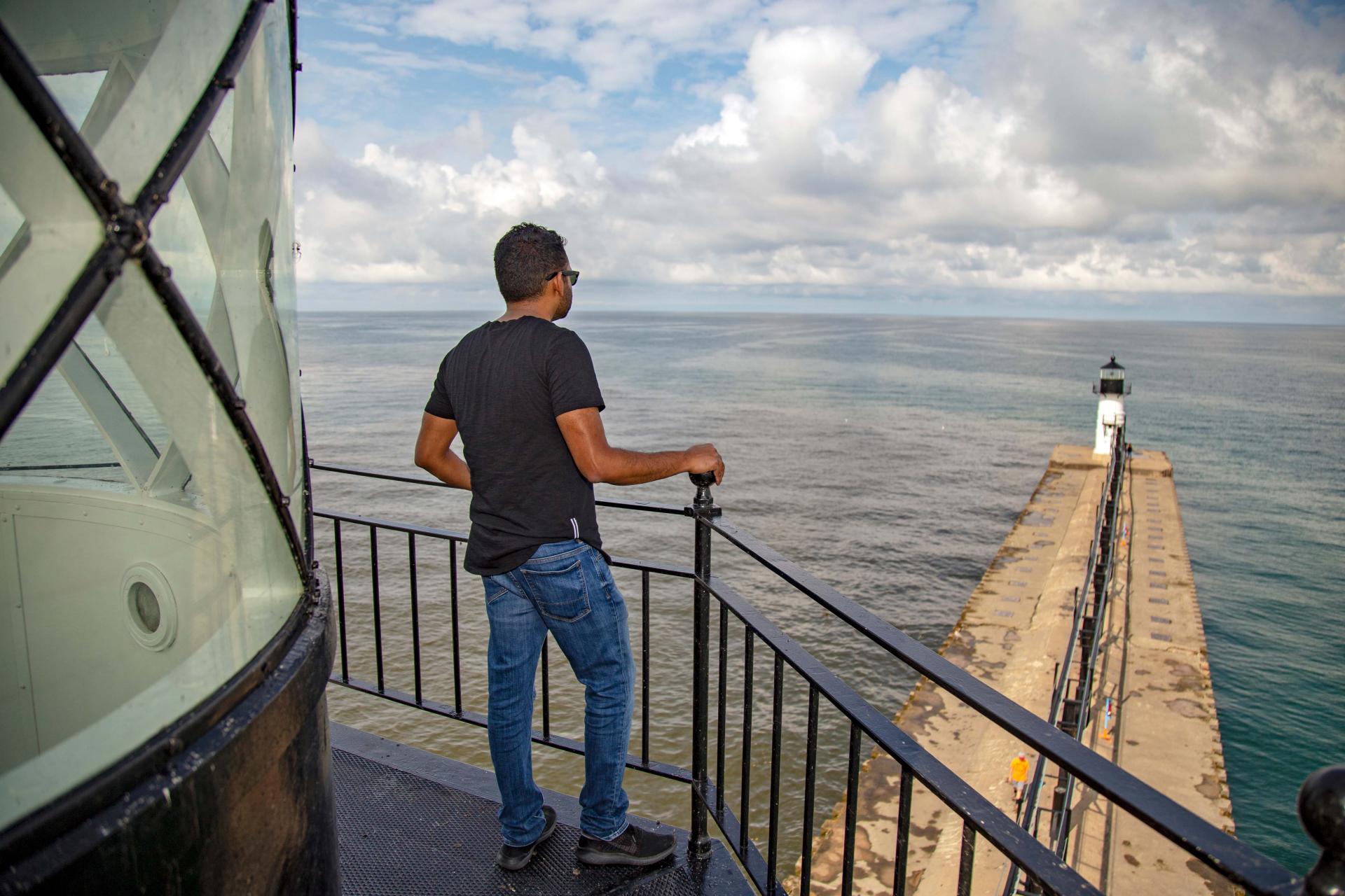 a man contemplating the view from the top of the lighthouse