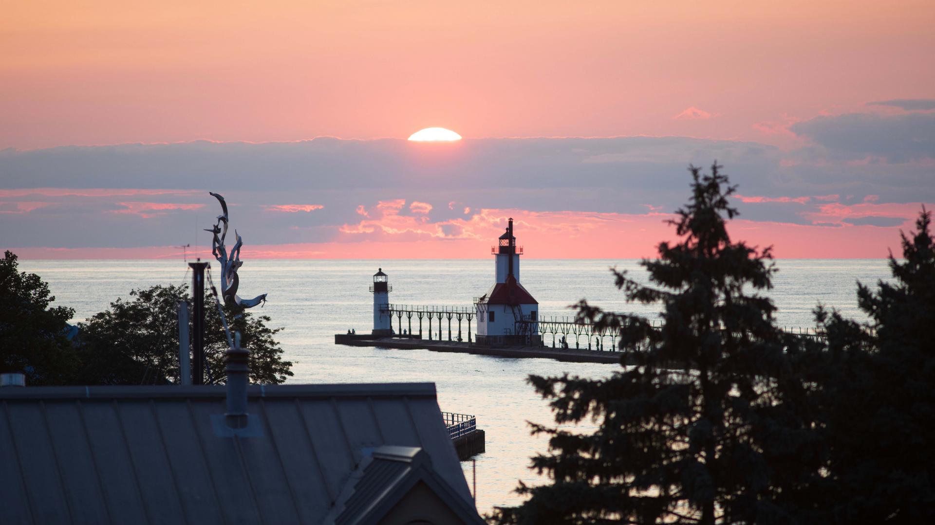 sunset over the lighthouse in st. joseph michigan