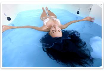 A woman floating in a sensory deprivation floatation tank