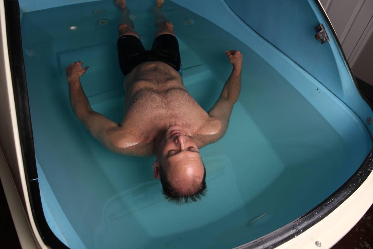 Man floating in a sensory deprivation floatation tank