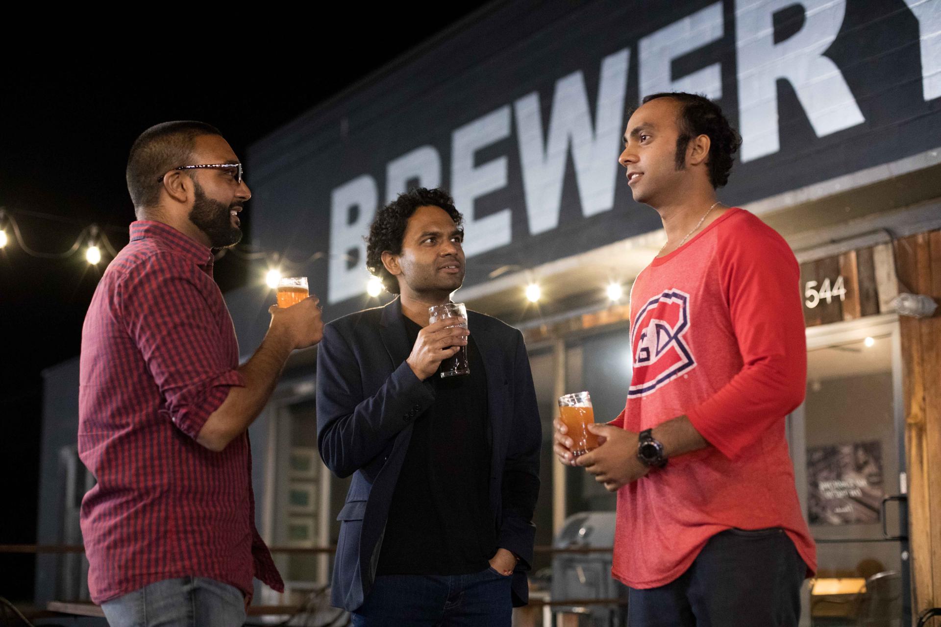 Three men drinking at ArcLight Brewing