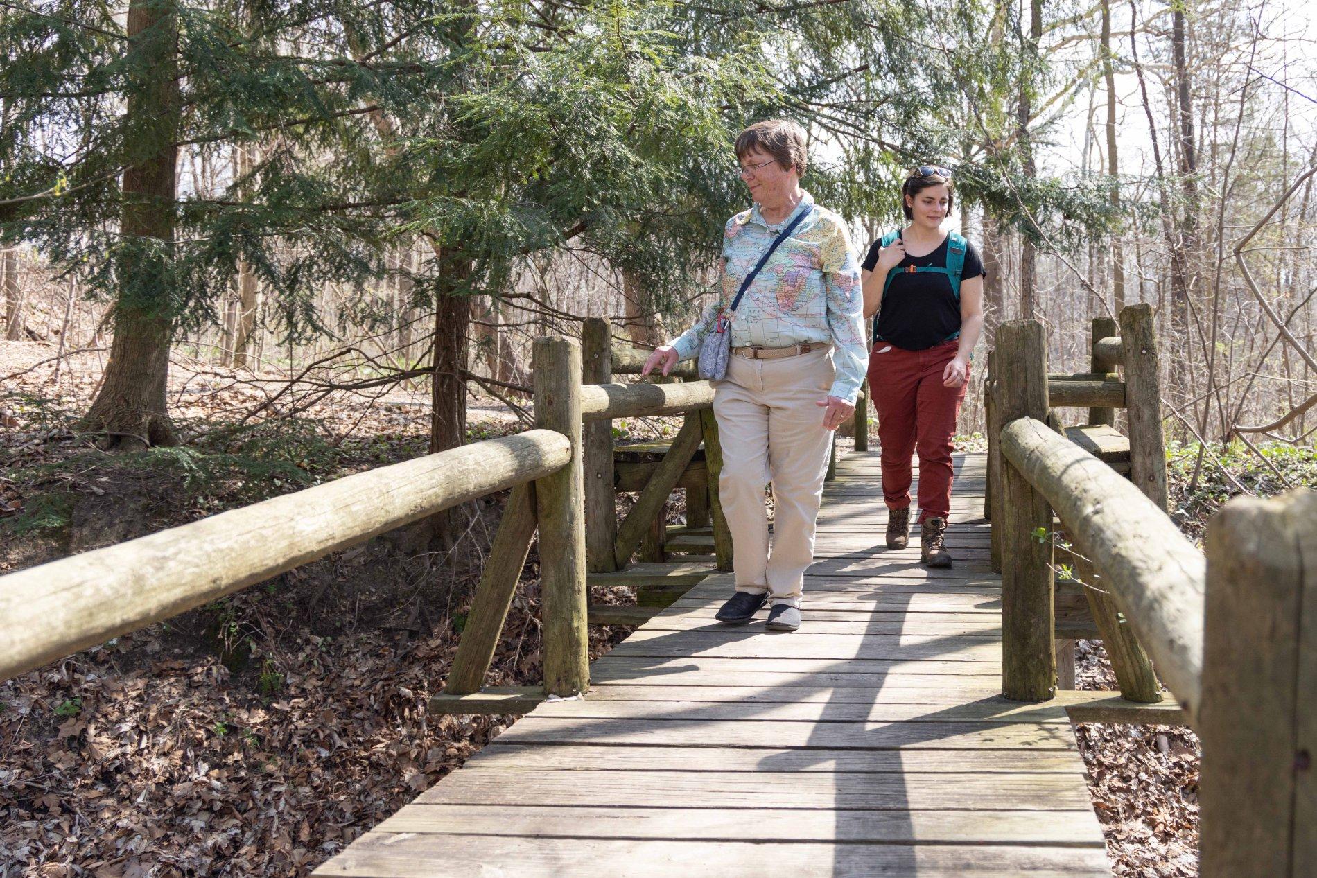 Two women on a bridge in Fernwood Botanical Garden