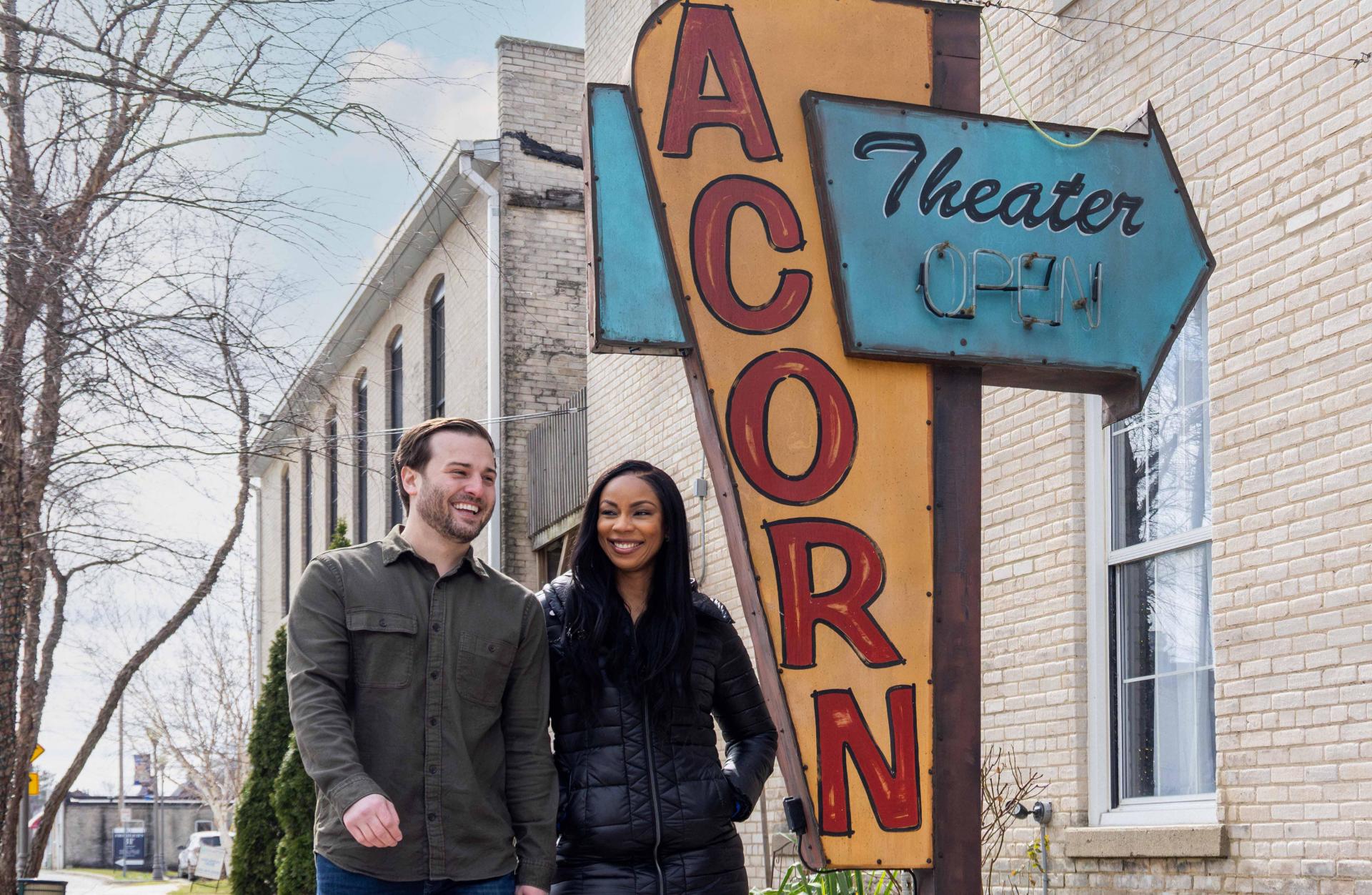 the acorn theater with a  couple outside fall time walking with coats on