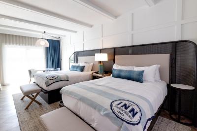 Double queen guest room featuring two comfortable queen beds, a seating area, and modern amenities for a relaxing stay.