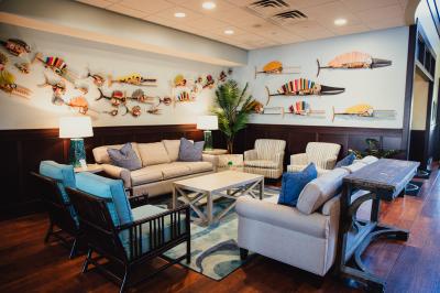 Lobby seating area with cozy chairs, and a coffee table, offering a welcoming space for guests to relax.