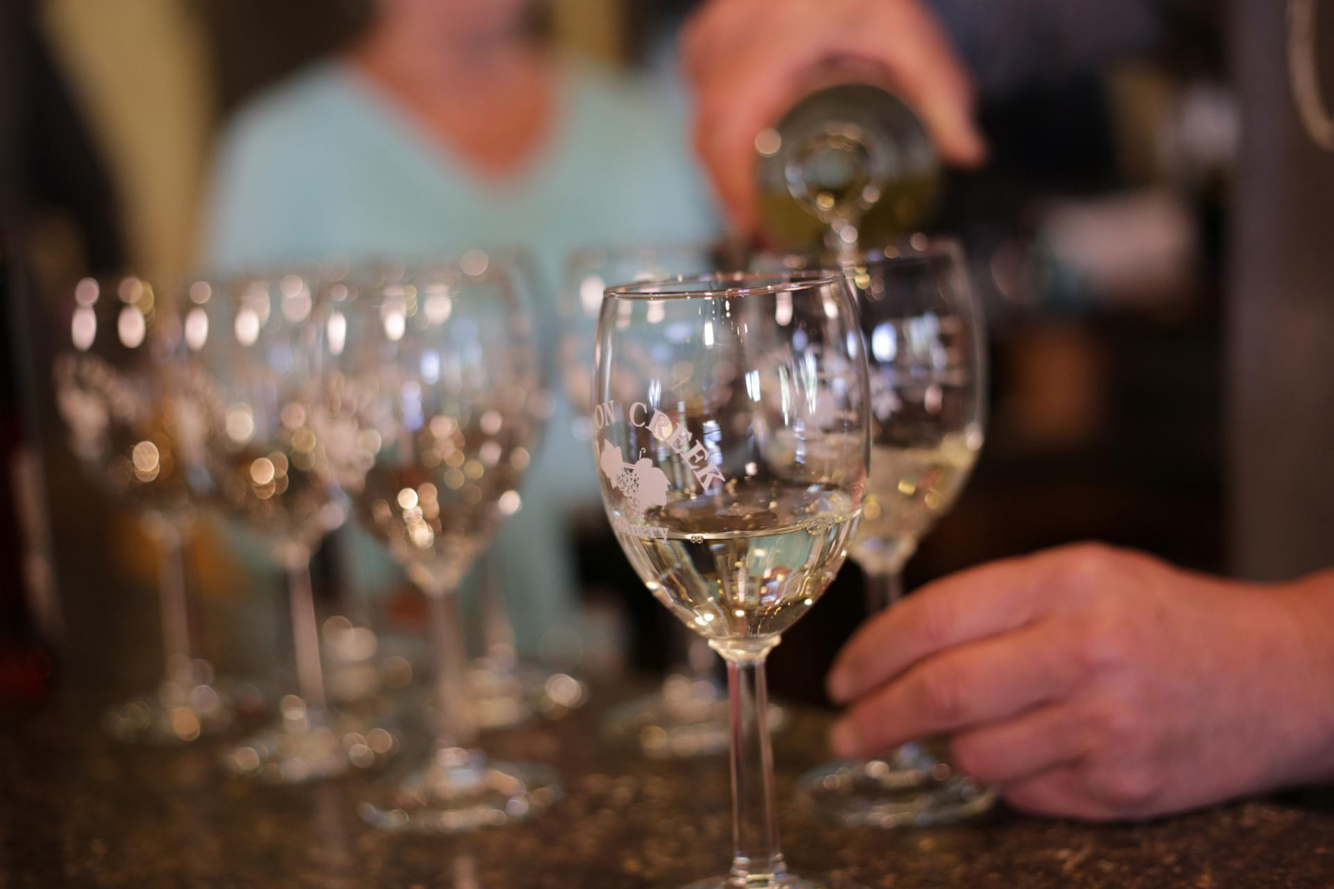 Lemon Creek Winery - wine pouring into glasses