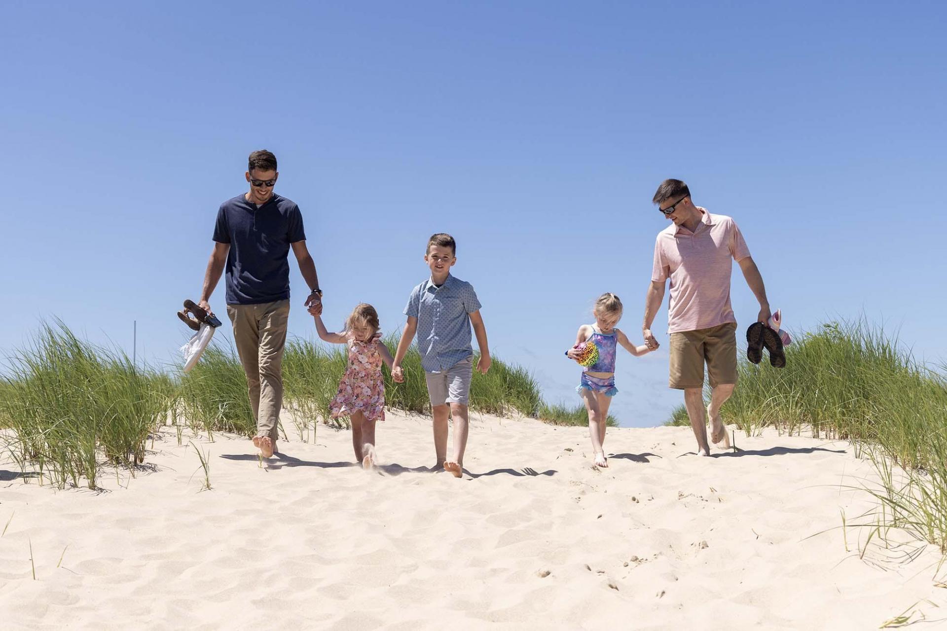 Parents and children walking to the beach.