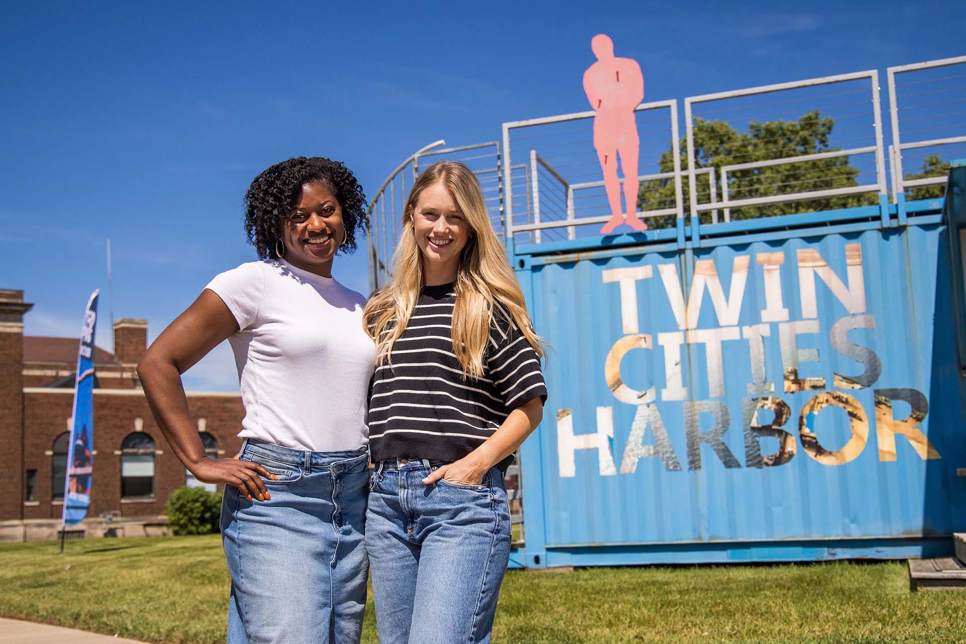 Two people in front of the welcome center in the Benton Harbor Arts District.