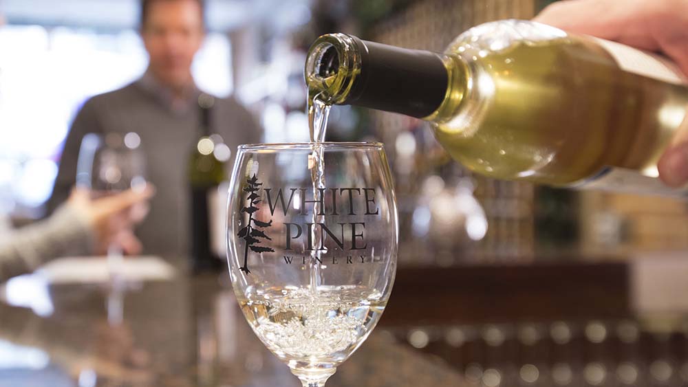 A glass of wine being poured