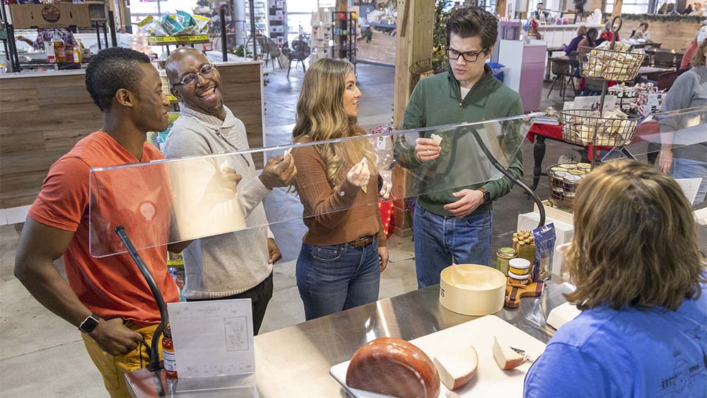 A group of people cheese tasting.