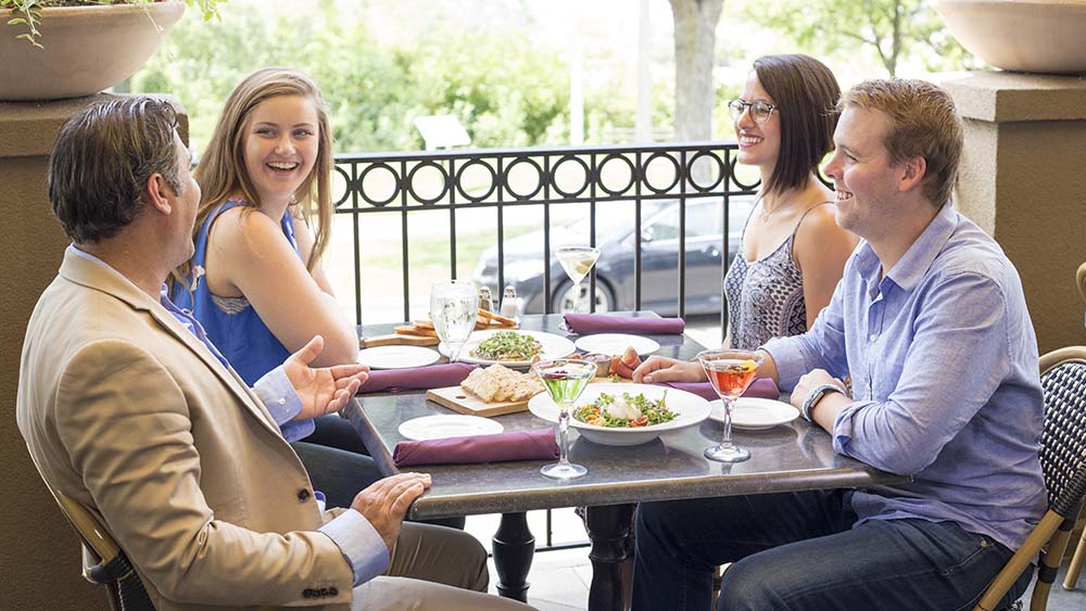 A group of people eating at the Bistro on the Boulevard.