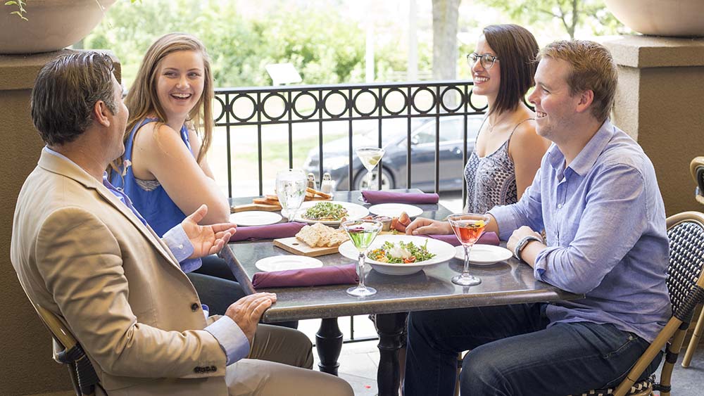 Four people enjoying a meal at the Bistro