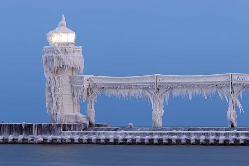 Outer lighthouse covered in ice photo by Joshua Nowicki.