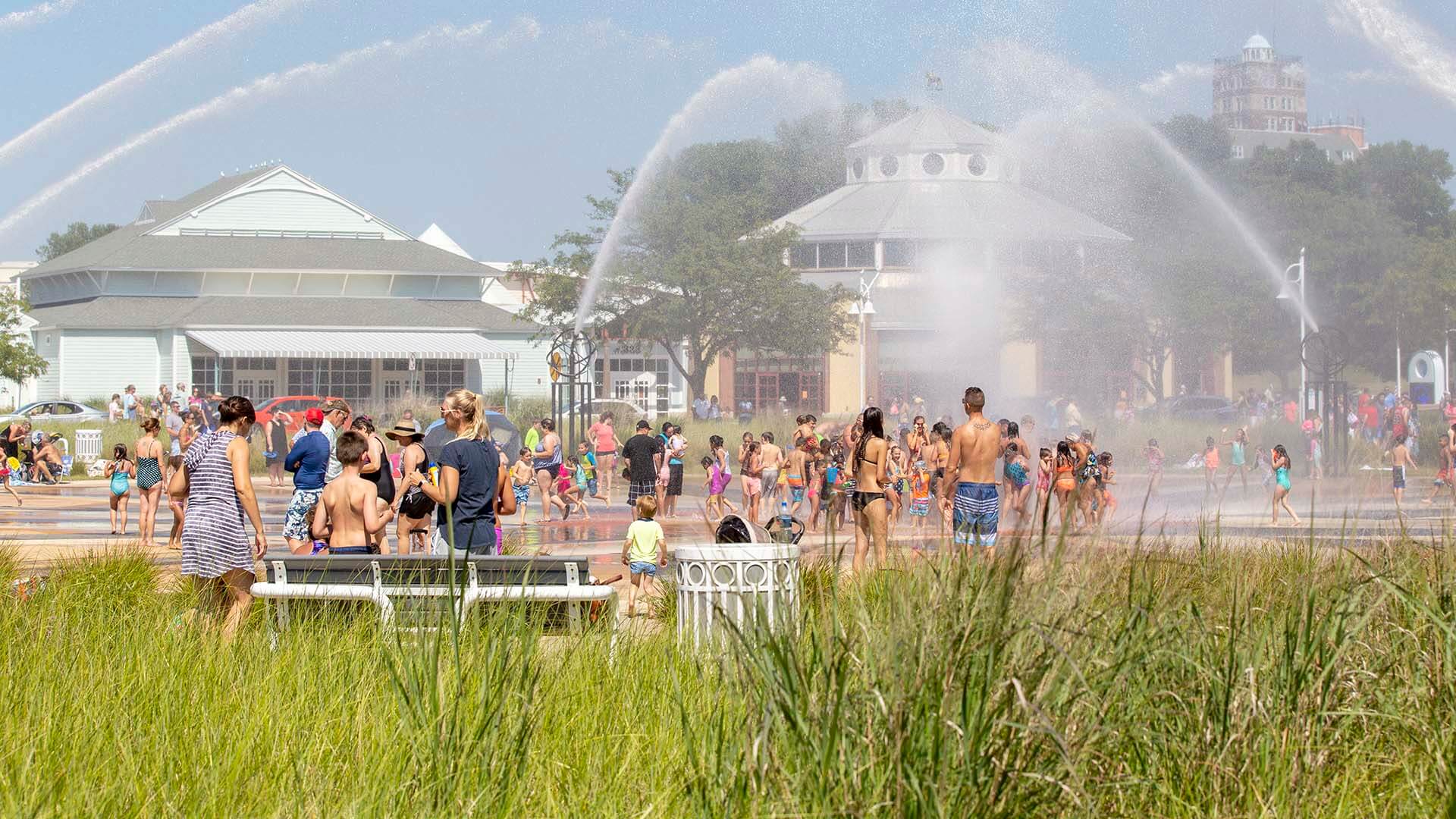 A photo of people playing in the Whirlpool Compass Fountain in St. Joseph, Michigan. 