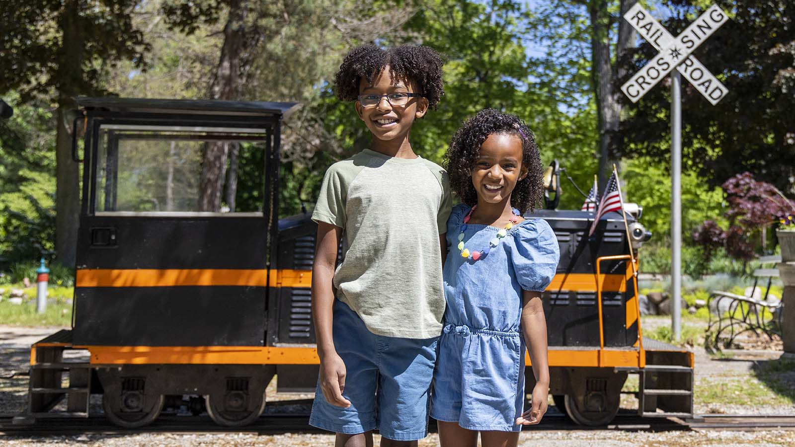 Two children posing in front of a train at Eden Springs.
