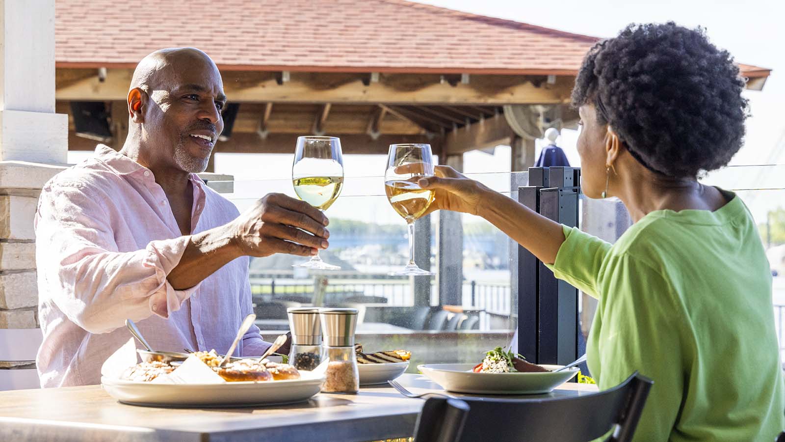 Two people enjoying a meal on the patio at Planks