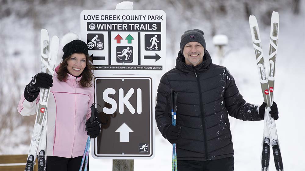Two people getting ready to ski at Love Creek.