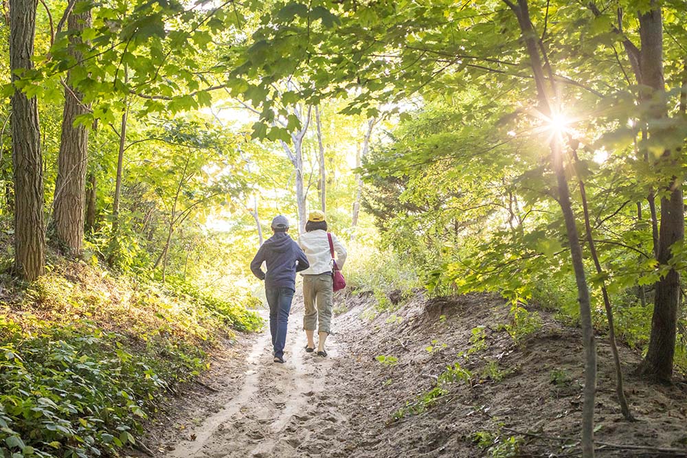Two people hiking at Grand Mere State Park