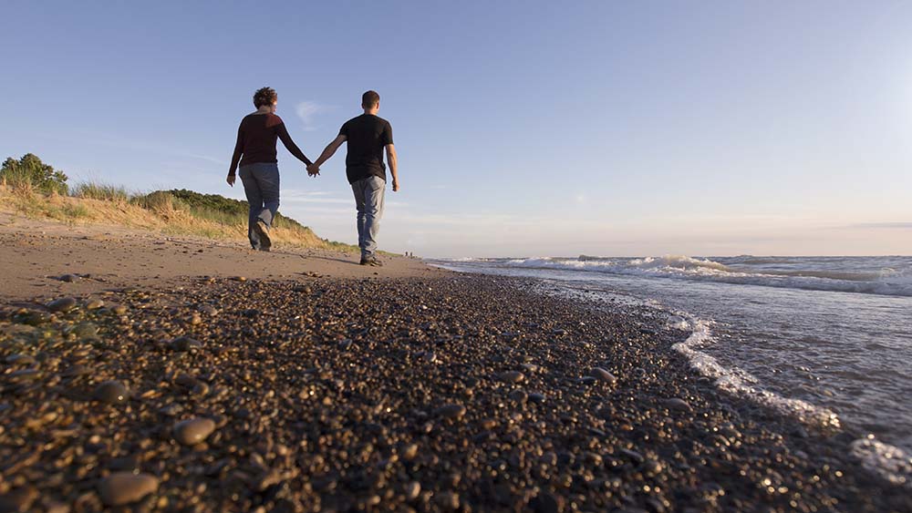 A couple walking along the beach.