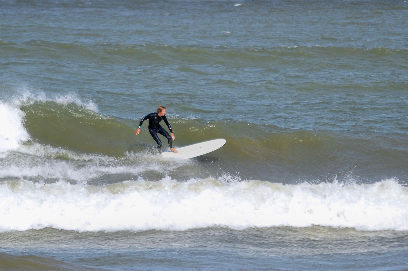 Ryan of Third Coast Surf Shop surfing Lake Michigan photo by Nowicki