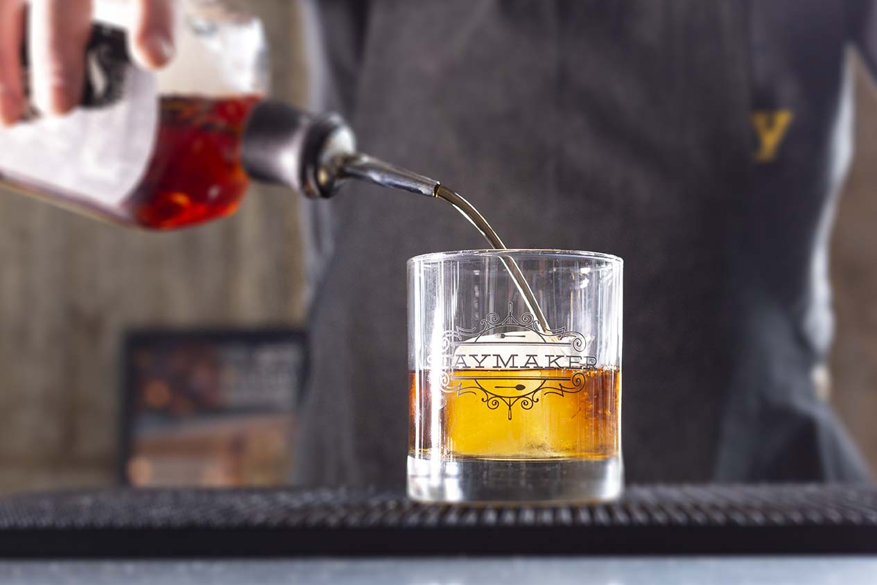 Bartender pouring a drink at Journeyman Distillery