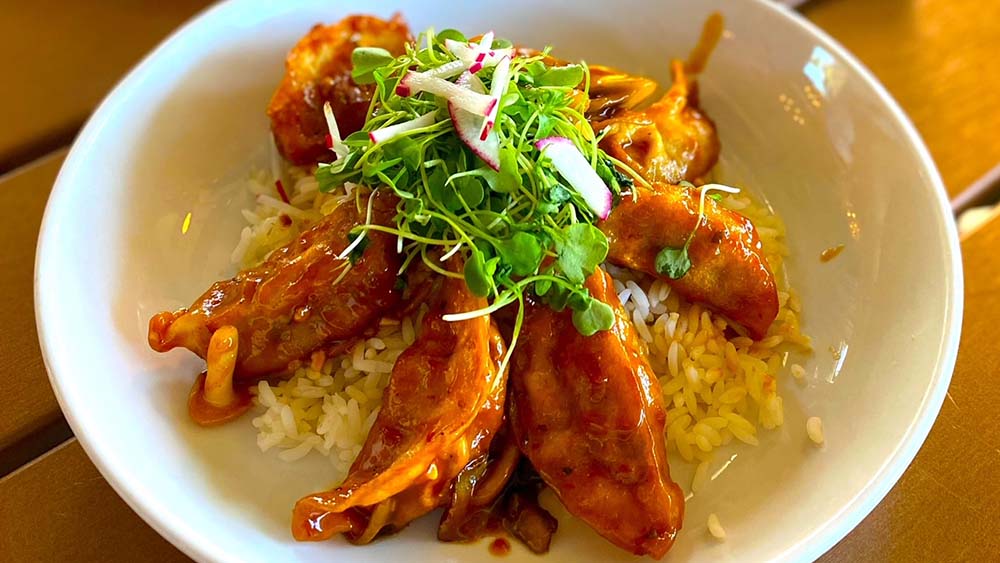 Duck-filled potstickers with a blend of seasonal mushrooms, sesame peanut sauce, scallions, micro-greens, chopped peanuts, and radish. 