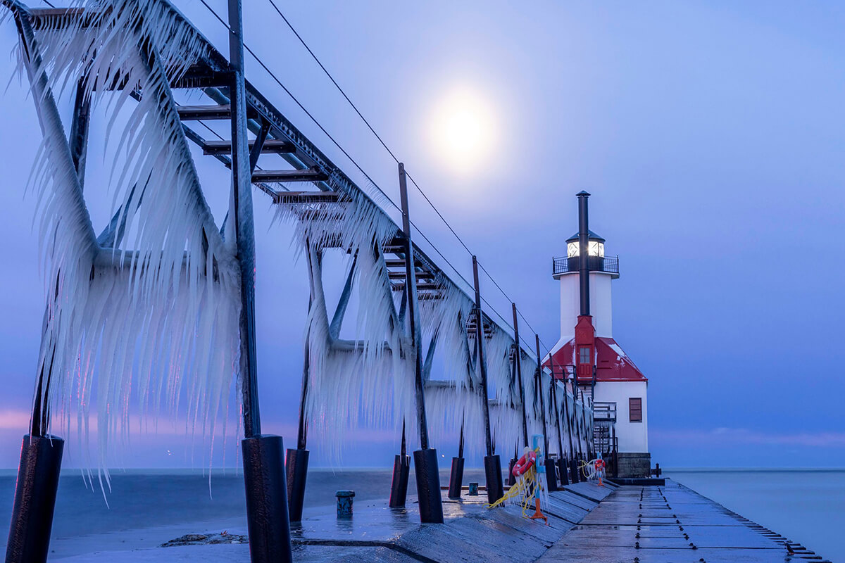 Moon over the lighthouse photo by Joshua Nowicki
