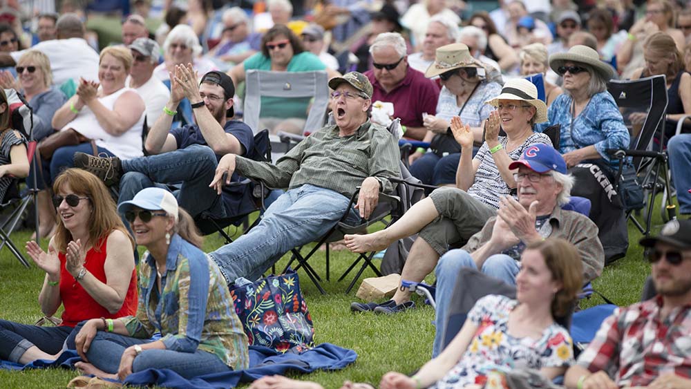 People happy and enjoying a concert