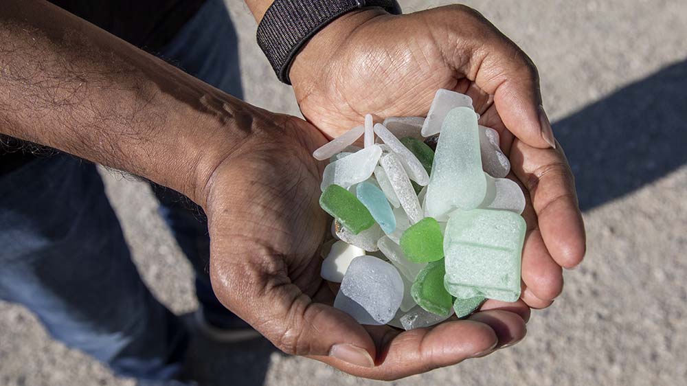 Hands full of beach glass.