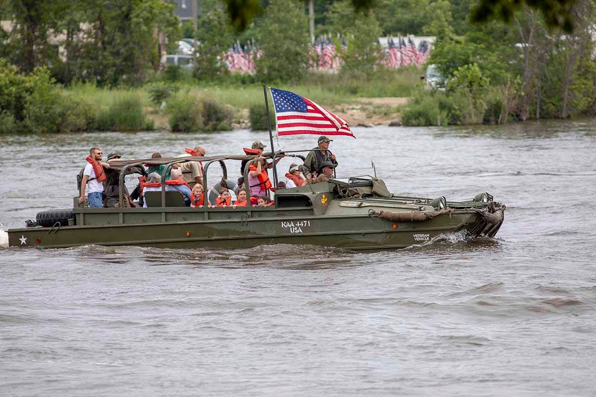 Veterans on a military boat parading on the st. joseph river