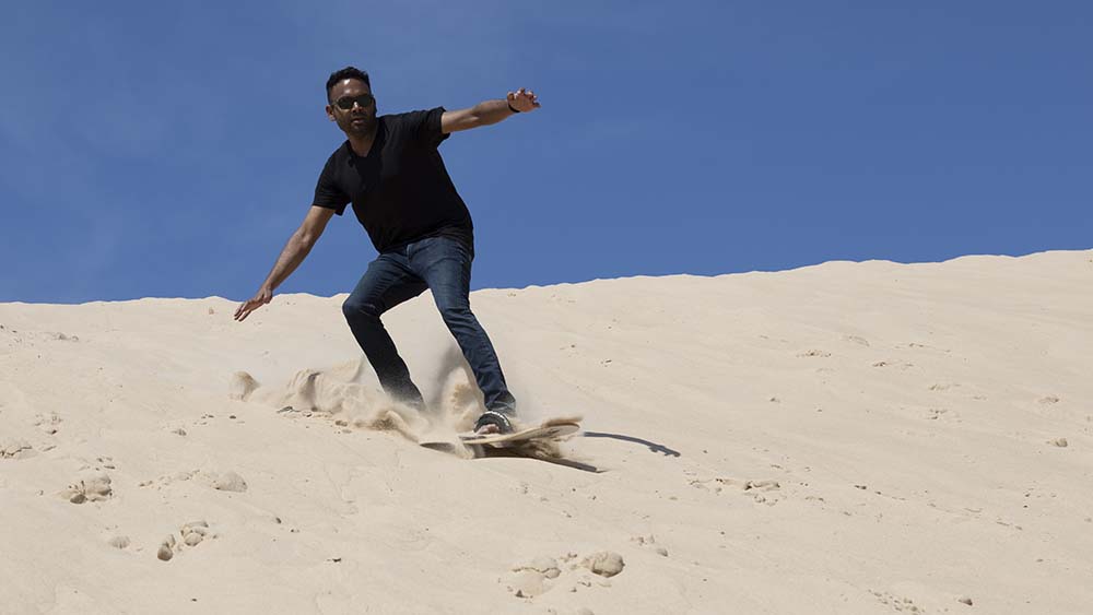 sandboarding on a dune at Warren Dunes