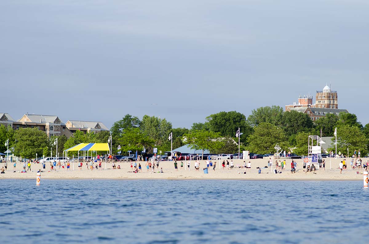 Beach goers spend a day on Silver Beach during their summer vacation