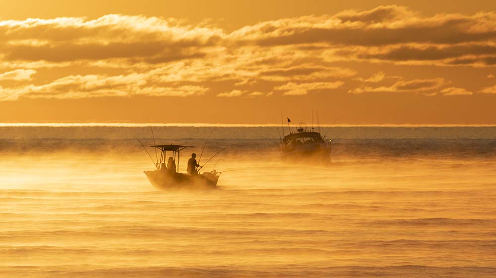 Two fishing boats on Lake Michigan on a foggy morning.