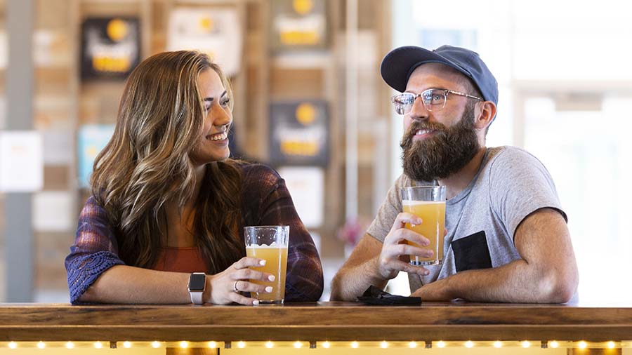 two people enjoying beers at the bar at Ghost Isle